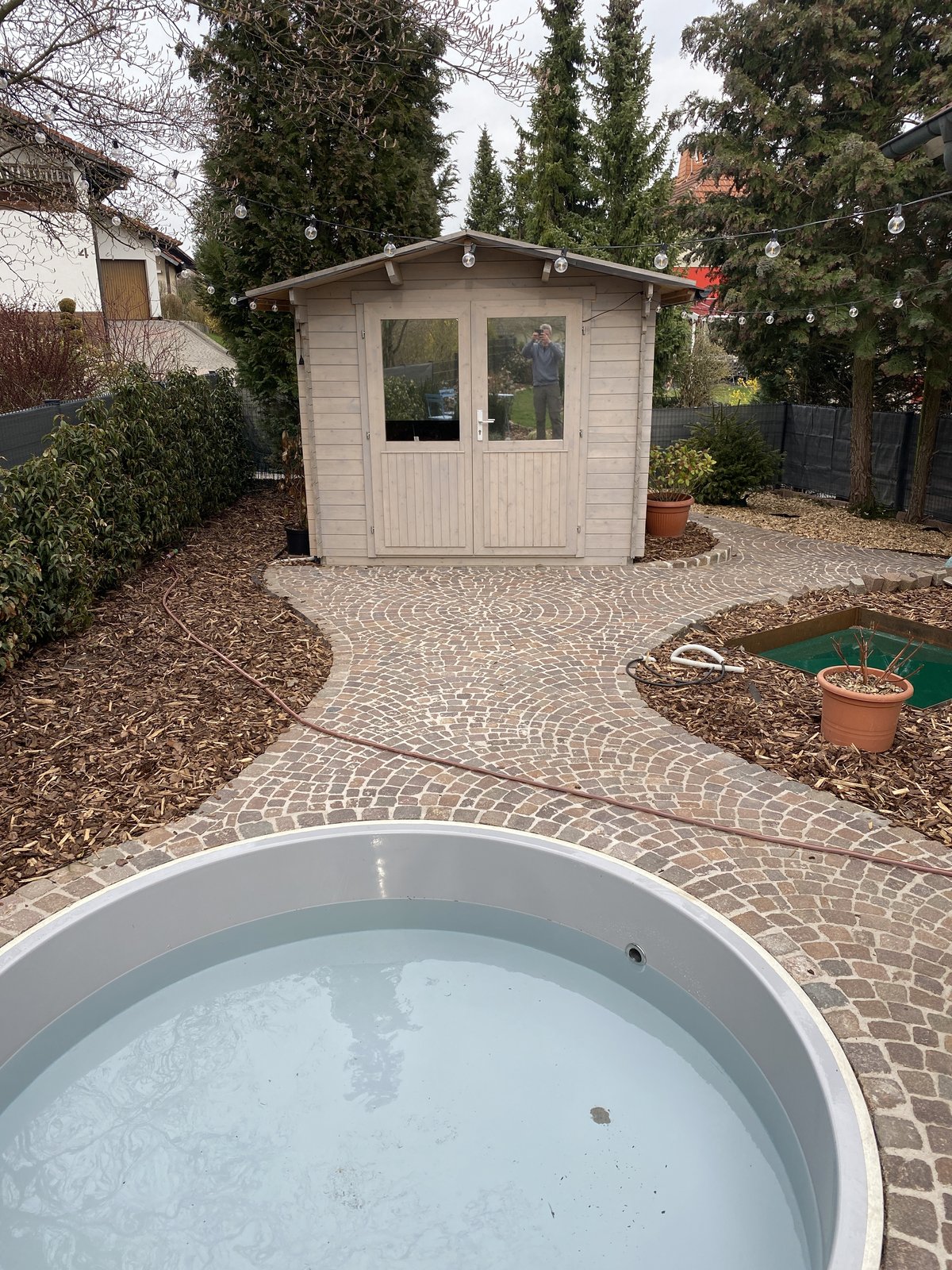 Gartengestaltung mit Natursteinpflaster und Pool